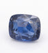 A cushion-cut blue sapphire gemstone with visible internal inclusions, photographed on a clean white background.
