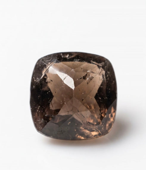 A cushion-cut smoky brown gemstone with visible internal inclusions and a faceted diamond-cut pattern, set against a plain white background.